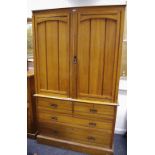 A satinwood linen press, two arched panelled doors enclosing sided to top,