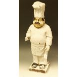 A cast painted plaster figure menu holder, as a chef, possibly shop display model,