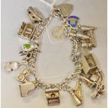 A silver charm bracelet and padlock with 17 charms,