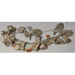 A silver charm bracelet and padlock with 23 charms,