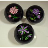 A set of three John Deacons 'J Glass' paperweights,