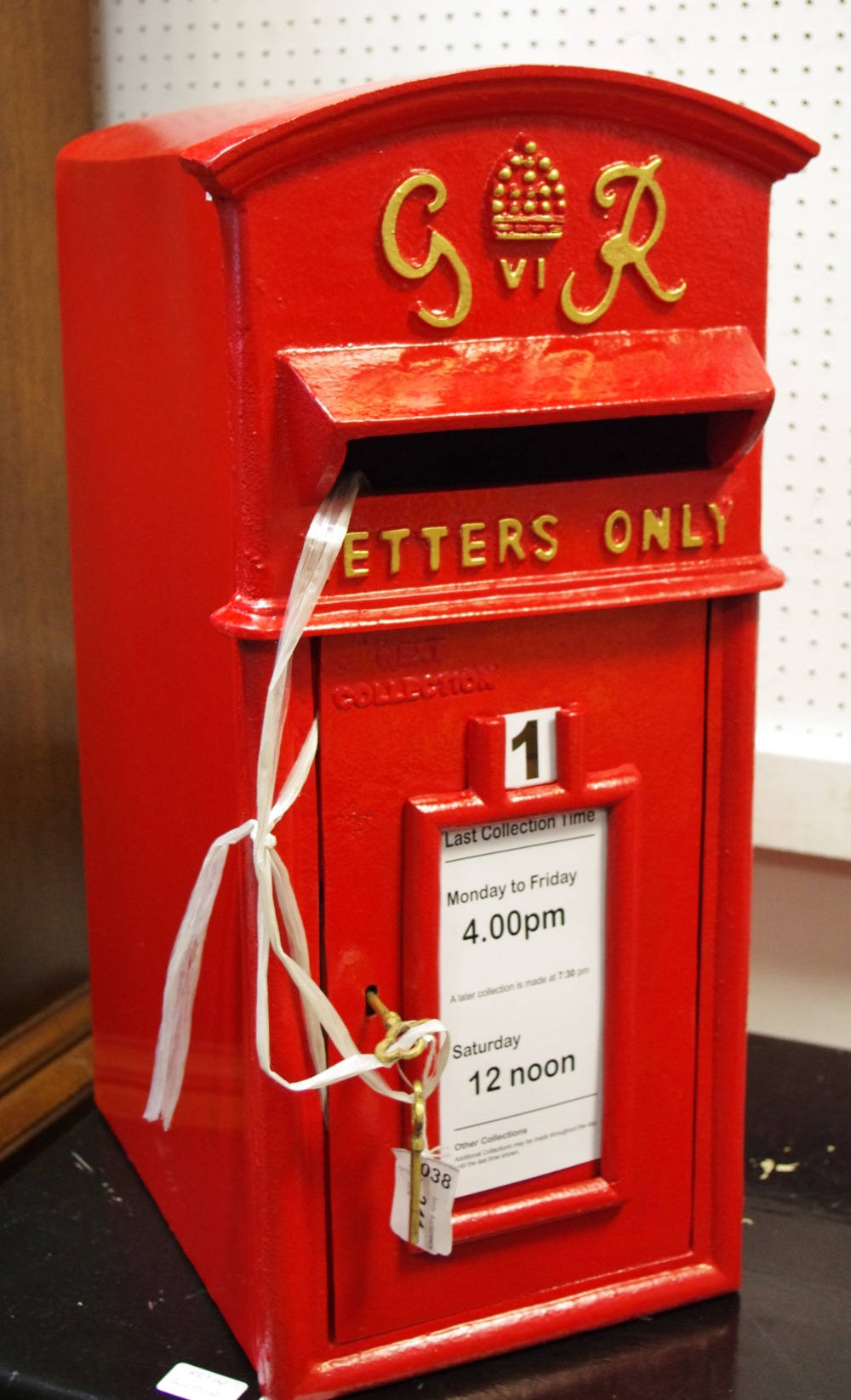 A reproduction cast metal George IV post box