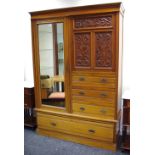 A Victorian mahogany double wardrobe, acanthus carved panel door above three short fluted drawers,