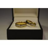 A pair of matching 18ct white and yellow gold wedding bands size R 1/2 and size M, 9.