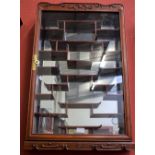 A Chinese style hardwood display cabinet, mirror backed, various display shelves,