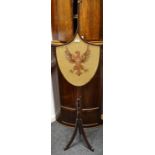 An early 20th century mahogany pole screen,