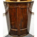 A George III mahogany bow-front corner cupboard,