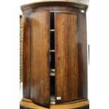 A George III oak and mahogany crossbanded bow front corner cupboard, moulded cornice, 99cm high,