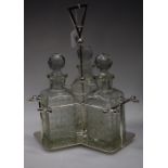 A Christopher Dresser style trefoil decanter stand with three decanters