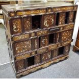 A late 19th Century Chinese cabinet, interior accessed by multiple sliding panels and drawers,