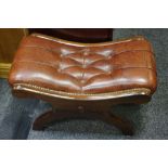 A 2Oth century leather and mahogany X framed foot stool Provenance: From the Estate of Lady