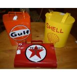 A reproduction petrol can, advertising Shell; others, Gulf,