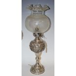 A 925 silver table lamp, the reservoir embossed with fruiting vine, knopped columns, domed base,