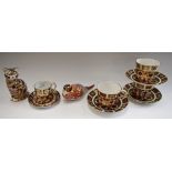 A set of three Royal Crown Derby 1128 pattern tea cups and saucers,