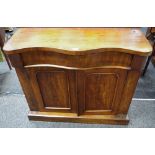 A Victorian mahogany chiffonier base, serpentine top over long drawer and two panel door cupboards,