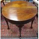 A George III mahogany tea table fold over hinged top opening to storage, tapering legs, club feet.