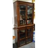 A late 19th Century mahogany display cabinet, four glazed doors, brass handles, adjustable shelves,