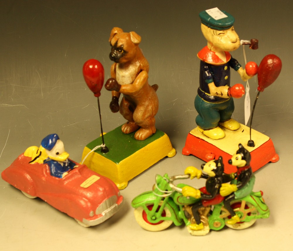 A reproduction cast metal figure, as Mickey Mouse riding a motorcycle; another,