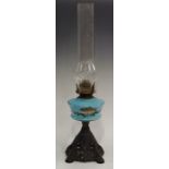 A Victorian blue milk glass and enamelled oil lamp (af)