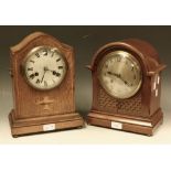 An Edwardian oak inlaid arched mantel clock, outlined with boxwood stringing with central urn motif,