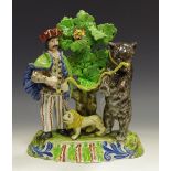 A Staffordshire figure group, of Saboyard and a dancing bear, modelled with his miniature lion,