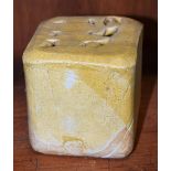 A salt glazed stoneware cube vase, by Eileen Lowenstein, of folded form, glazed throughout in ochre,