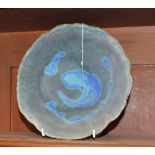 A stoneware raku glazed bowl, by Usha Khosla, of irregular form,