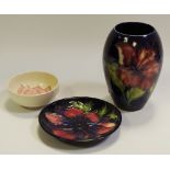 A Moorcroft Magnolia pattern pin dish; another smaller;