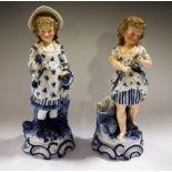 A pair of 19th century Continental Ernst Bohne & Sohne figural spill vases, picked out in blue,