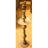 A tall floor standing brass alter type candlestick, dished drip tray,