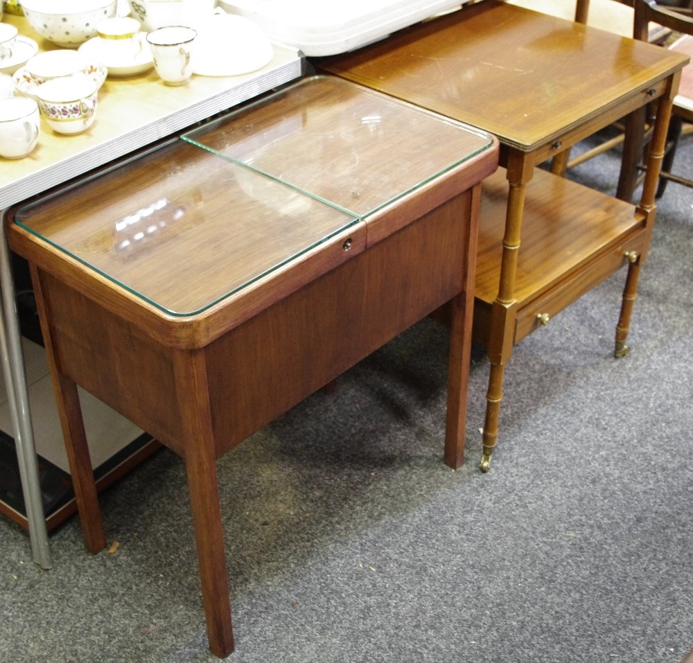 A reproduction mahogany occasional table with draw slide above under gallery holding one long