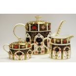 A Royal Crown Derby 1128 pattern tea pot; a similar sucrier and milk jug,