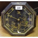 A black lacquer octagonal boudoir timepiece, with Chinoiserie landscape, Roman numerals, 21cm, c.