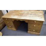 A contemporary pine pedestal desk