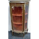 A Louis XVI style gilt metal and mahogany bow fronted display cabinet,