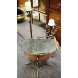 A copper coal scuttle and cast iron stand, a large cast iron candllestick; another,
