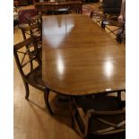 A reproduction dining suite comprising of large table with eight Regency inspired dining chairs and