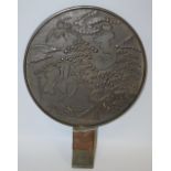 A Japanese bronze 'Meiji' period mirror, decorated with cranes amongst blossoming prunus,