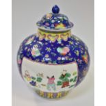 A Chinese blue and pink jar and cover, bulbous body decorated with three figural panels,