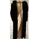 A lady's black velvet overcoat;