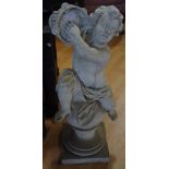 An 18th century style composition garden statue, of a scantily clad putto playing a tambourine,