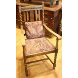 A carved oak open arm chair,