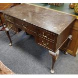 A reproduction dressing table, rectangular top, one long and four short drawers, cabriole legs,