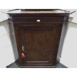 A George III oak corner cupboard c.
