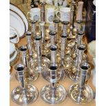 Thirteen silver plated ejector candlesticks, dish bases,