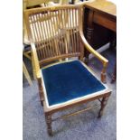 An Edwardian mahogany library chair, slatted back, open arms, padded seat.