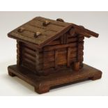 A Black Forest novelty inkwell, as an alpine chalet, hinged cover enclosing a glass liner, c.