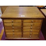 A 12 drawer bobbin chest, two flights of six drawers, brass button handles, 34cm high x 48.