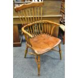 An ash and elm spindle back chair, shaped top rail, saddle seat,