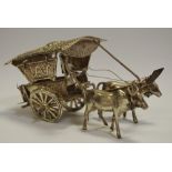 An Asian silver coloured metal model of an ox drawn cart